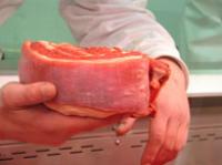 Hand holding a cut of beef
